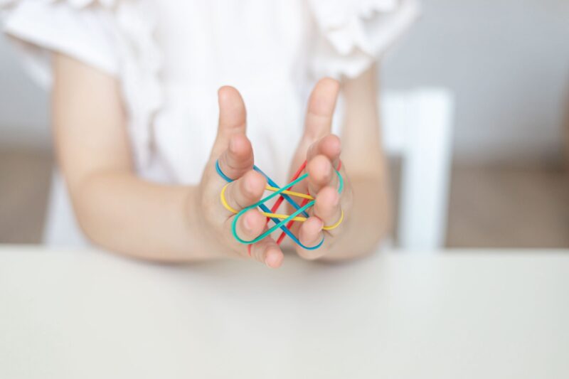 Hand Strengthening Exercise For Kids , Adults, Seniors. Child Using Rubbers For Stronger Hands. Hand Strengthening Exercise For Kids , Adults, Seniors. Child Using Rubbers For Stronger Hands.